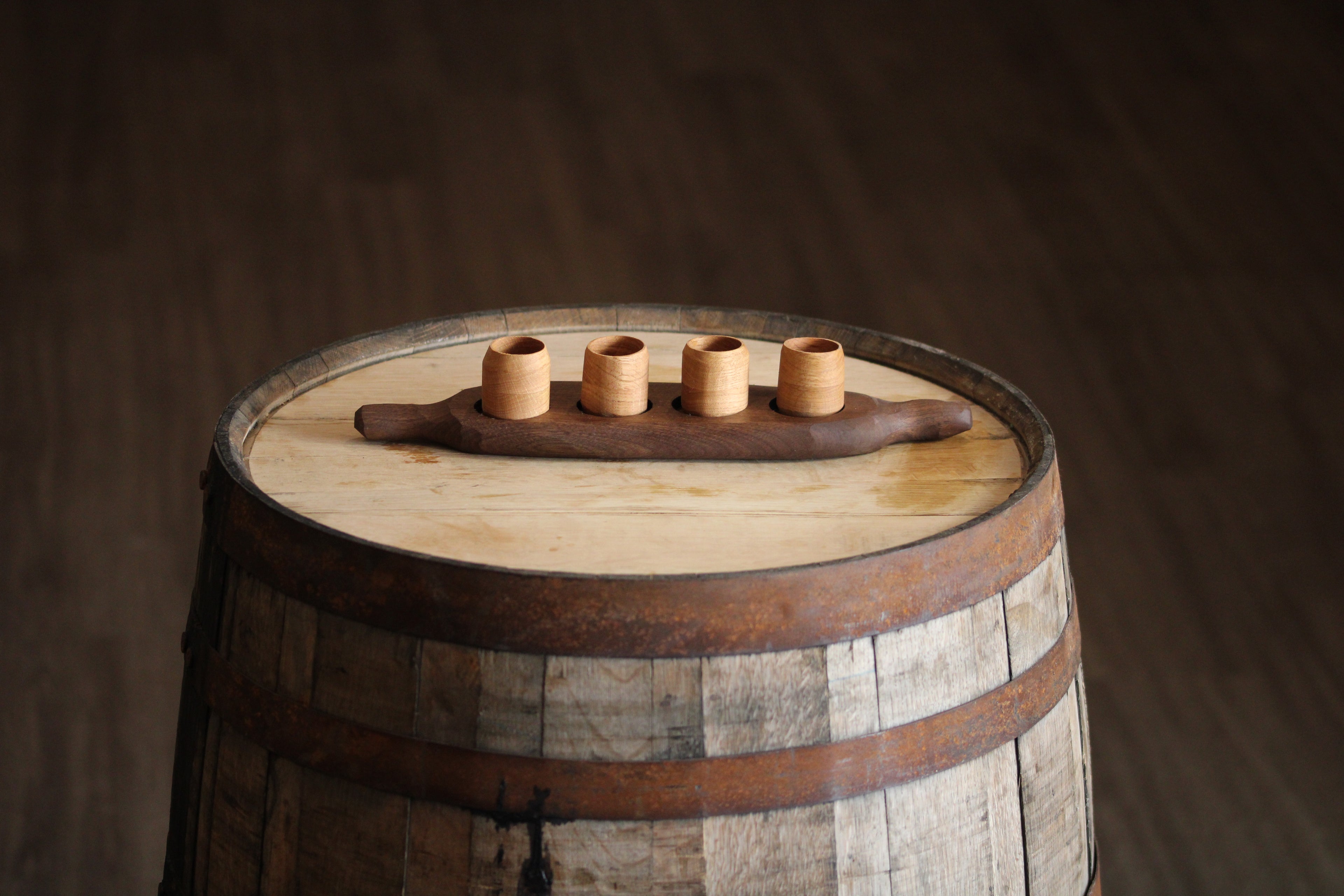 Set of four wooden shot cups on walnut  shot glass flight board.
